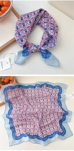 Close-up of checkers pattern silk scarf with retro characters and Hello text border