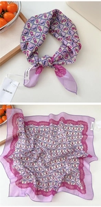 Detail of purple checkered scarf with cartoon figures and decorative wavy borders