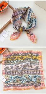 Detail of vintage square scarf with bohemian floral patterns and soft pastel color blocks