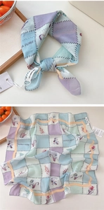 Macro shot of macaron checkered scarf with floral prints and cotton-linen texture