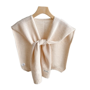 Elegant beige floral crochet knit shawl tied over a hanger for women stylish layering