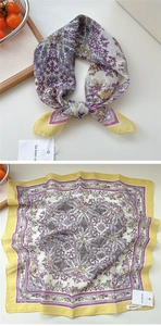 Dettaglio di un foulard vintage in seta con stampa paisley giallo e viola e bordi a mano