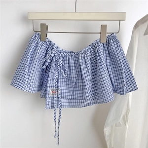 Close-up of blue and white gingham layering skirt with elastic shirring and side ties
