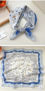 Dettaglio di un foulard quadrato in seta con motivi paisley blu e piccole stampe floreali