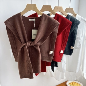 Knit wool shawl featuring cable pattern and tie-front design in three classic colors