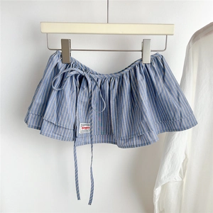 Detail of blue and white striped tiered skirt accessory with ruffled hem and drawstring