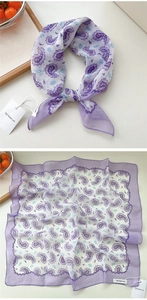 Dettaglio di un foulard di seta viola con motivo paisley e delicate decorazioni floreali