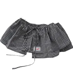 Gingham layered skirt panel with ruffled edges and tie closure for versatile styling