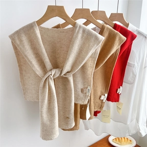 Three colors of knitted 100% wool shawls in beige, brown, and red on white shirts