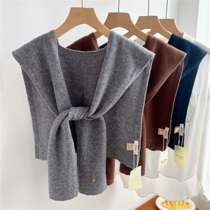 Three premium pure wool knitted shawls in grey, brown and navy blue on hangers
