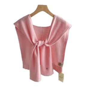 Pink 100% wool knitted shawl wrap on a wooden hanger with long tie-knot design