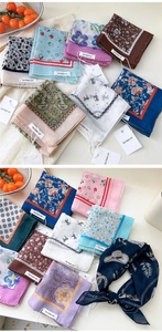Macro shot of assorted floral and paisley cotton linen square scarves with brand tags