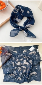 Detail of dark blue silk scarf with western patterns and a premium brand tag