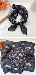 Macro view of black cotton-linen scarf with western cowboy horse and cactus motifs