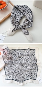 Detail of vintage floral cotton linen scarf showing texture and elegant black flower patterns