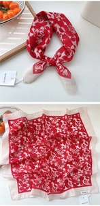 Detailed texture of a red floral cotton linen square scarf with knotted styling