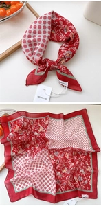 Detail of red floral patchwork cotton linen scarf with polka dots and knotted styling