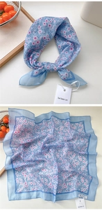 Detail of light blue floral cotton linen square scarf with delicate edge stitching