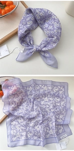 Close-up of light purple floral silk scarf tied as a stylish headband and neckerchief
