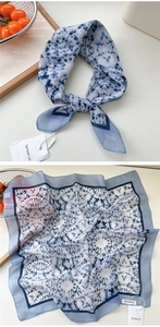 Detail of blue and white tie-dye cotton linen scarf showing soft texture and border