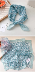 Detail of light blue floral cotton linen square scarf with small white flower patterns