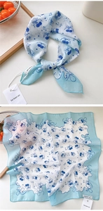Detail of blue cherry print cotton linen scarf showing texture and pattern layout