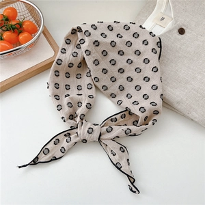 Detailed texture of beige linen polka dot neckerchief with black circle embroidery details