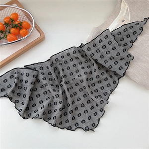 Close-up of gray cotton neckerchief with black polka dots and delicate wavy edges