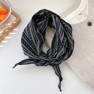Detail of vintage striped cotton linen neck scarf with black and white polka dot pattern