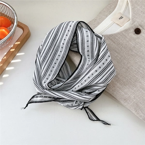 Detail of striped linen-cotton neck scarf with polka dots and frayed edge detail