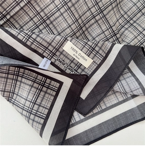 Detail shot of the 100% cotton material showing the black and gray plaid fabric texture