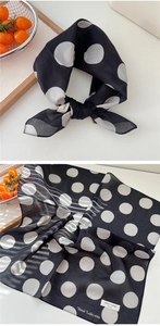 Macro detail of breathable cotton square scarf with black polka dots and hem text