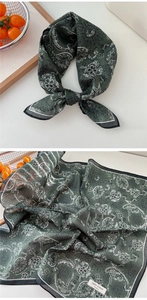 Detail of green paisley cotton bandana showing soft texture and premium print quality