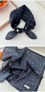 Detail of 100% cotton navy blue paisley bandana with heart and star patterns