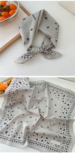 Macro detail of a 100% cotton grey paisley square scarf with delicate heart patterns