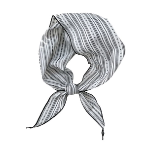 Classic black and white striped cotton-linen neck scarf tied in a bow on white background