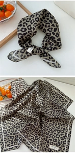 Detail showing folded 100% cotton square scarf with black leopard print on grey-green