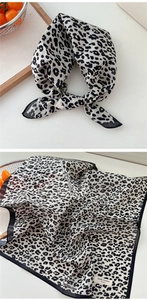 Detail of leopard print cotton neck scarf showing soft texture and premium material