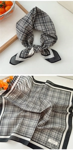 Close-up of black and white checkered cotton scarf with detailed weave and rolled hem
