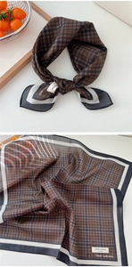 Detail of 100% cotton brown checkered scarf with contrast borders and soft texture