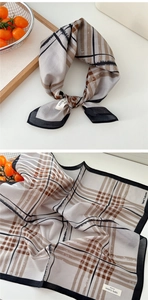 Detail of soft breathable cotton plaid scarf with classic checkered pattern and black border