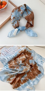 Detail of blue and brown tie-dye cotton scarf featuring a 100% cotton wash label