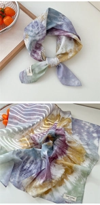 Detail of soft tie-dye cotton scarf showing purple and yellow breathable fabric texture