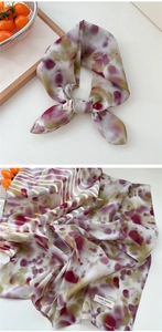 Detailed view of 100% cotton floral scarf with artistic watercolor pattern and soft texture