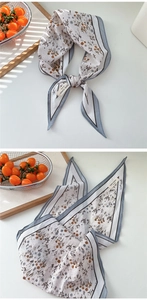Detail eines Rauten-Baumwolltuchs mit Blumenmuster und hellblauem Rand für Damen