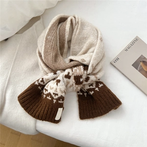 Detailed knit texture and ribbed edge of a geometric pattern winter scarf