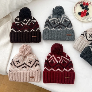 Winter knitted beanie with pompom and Nordic pattern in four distinct colorways