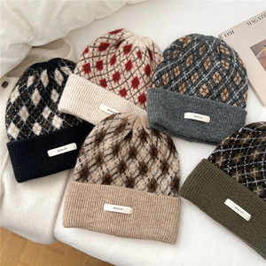 Winter knitted beanie hats with diamond lattice pattern in multiple colors on white background