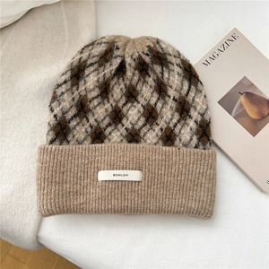 Detailed close-up of diamond pattern knit texture and stitched brand label on winter hat