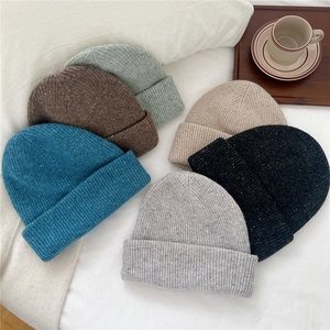 Winter wool knitted beanie hats for women in multiple colors shown in a cozy setting